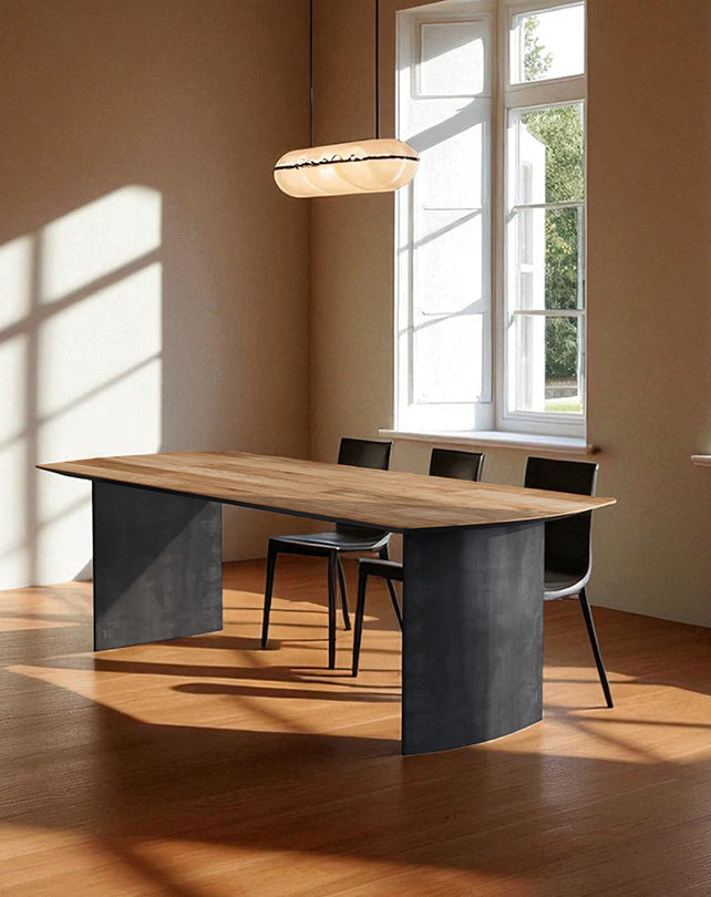 Modern dining table with black metal and wood design in a well-lit room.
