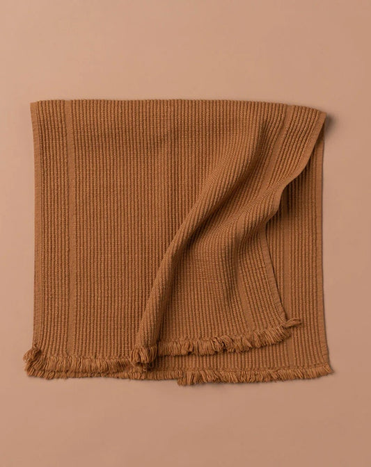 Brown textured blanket on a beige background