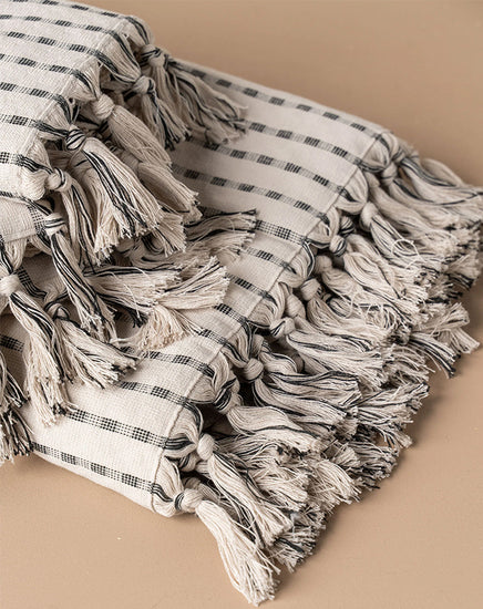 Textile with tassels on a beige background