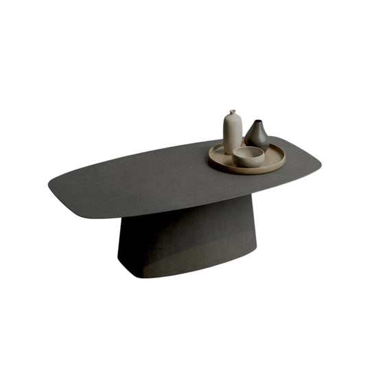Modern dark gray coffee table with decorative items on a white background
