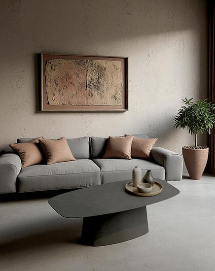 Modern living room with a gray sofa, coffee table, and decorative elements.
