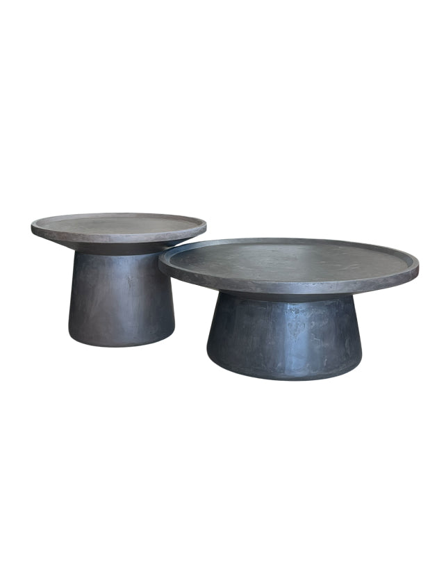 Two concrete side tables on a white background