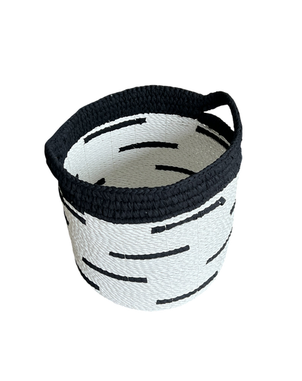 Black and white woven basket on a white background