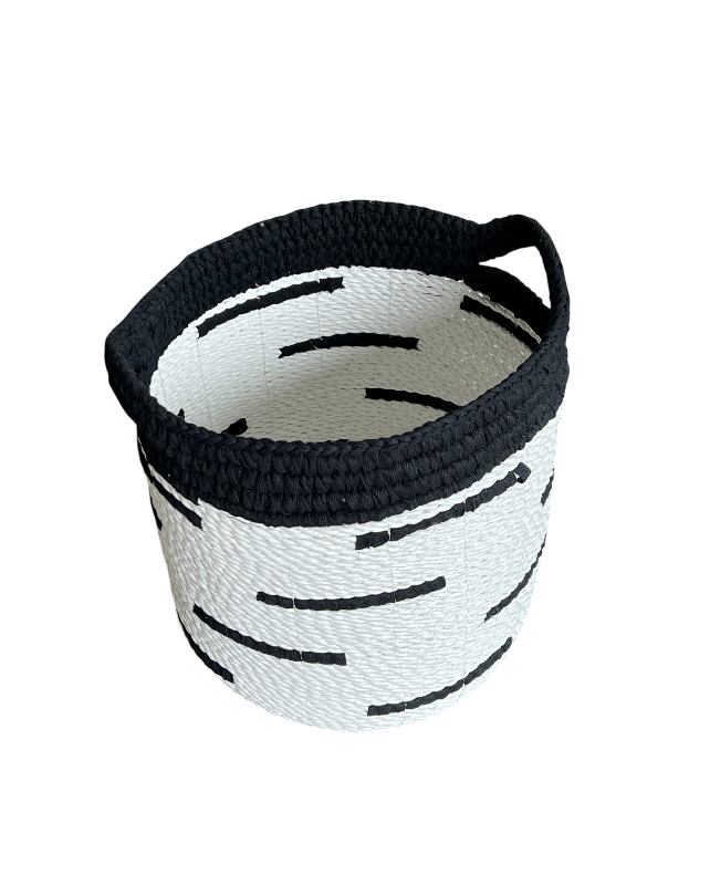 Black and white woven basket on a white background