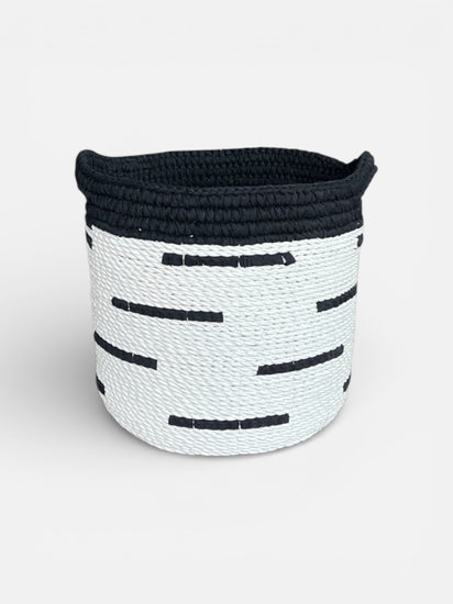 Black and white woven basket on a light gray background