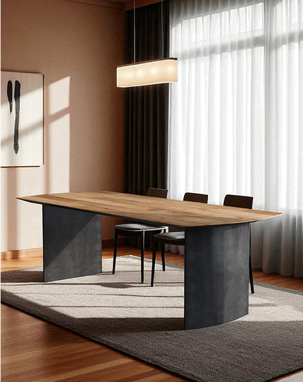 Modern dining table with black metal and wood design in a well-lit room.