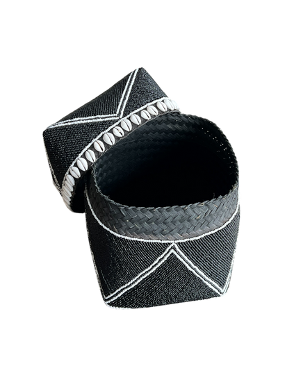 Black woven bracelet with white accents on a white background