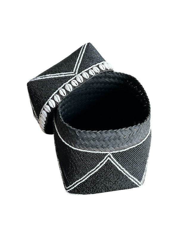 Black woven bracelet with white accents on a white background