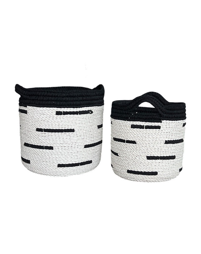Two woven baskets with black and white pattern on a white background